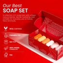 Eine rote Geschenkbox mit sechs mehrfarbigen Seifenstücken und Symbolen, die PETA-zertifizierte, vegane und chemiefreie Formeln hervorheben.