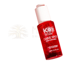 Ein leuchtend rotes glasfläschchen mit weißem pumpenspender und koji white serum zur aufhellung von dunklen flecken