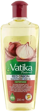 Vatika naturals kräftigendes ayurvedisches haaröl in klarem flasche mit rotem deckel und zwiebel schwarzkümmel kokos