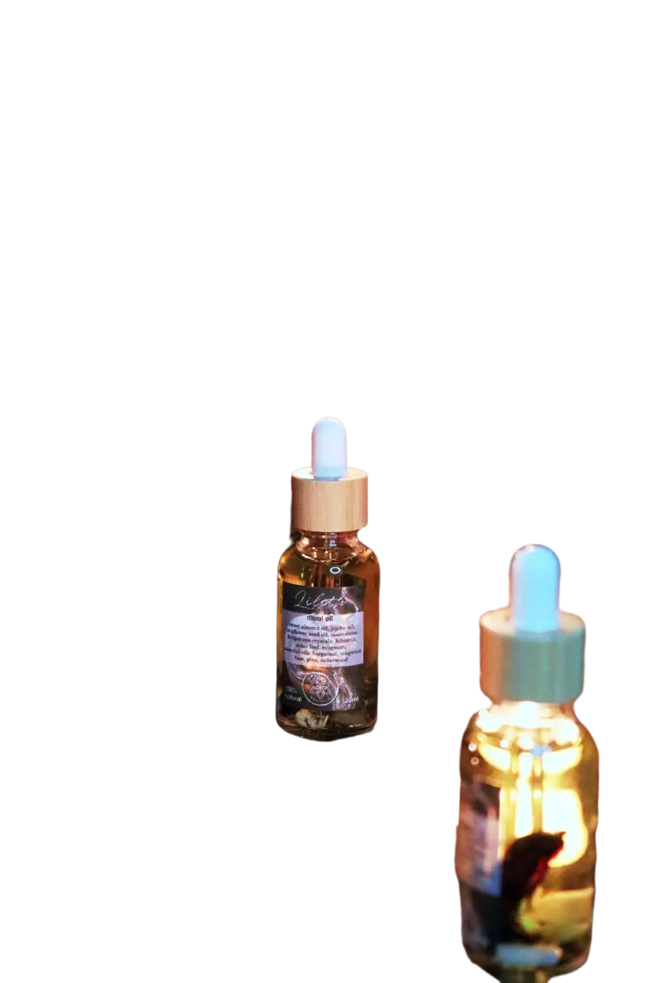 Ätherisches Lilith Öl von Ayamani Naturals mit Mondstein- und Tigeraugenkristallen, geeignet für feminines Ritual und Entspannung.