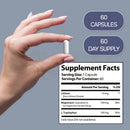 Weiße längliche kapsel lithium orotat 10 mg mit magnesium taurat und l-tryptophan für balance gehalten zwischen fingern