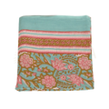 Folded turquoise cotton lunghi sarong with vibrant pink blossoms gold leaves and decorative stripes from mana shop