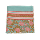 Folded turquoise cotton lunghi sarong with vibrant pink blossoms gold leaves and decorative stripes from mana shop