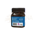 Ein dunkles bernsteinfarbenes glasglas mit schwarzem rippenverschluss und blauem etikett mad honey nepal honig aus kathmandu