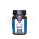 Ein braunes glasgefäß mit schwarzem deckel und blauem etikett mit rosa text für 100% reinen traditionellen geernteten honig von mad honey nepal