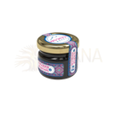 Kleines dunkles glas mit goldenem deckel und buntem etiket von moschato nepal für mad shilajit nepal resin