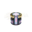 Ein kleines glasgefäß mit golddeckel und lila-blau-weißem etikett enthält 25 g shilajit resin von mad shilajit nepal