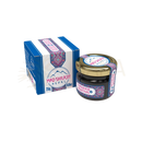 Ein kleines glas mit goldverschluss und blau-rosa etikett mit bergmotiv für mad shilajit nepal shilajit resin