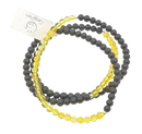 A set of mala kurz ebenholz bracelets with matte black and translucent yellow beads with silver accents from mana shop