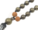 A mala pyrit necklace from mana shop featuring metallic greenish-brown pyrite and orange buddha seed beads
