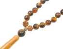 A beaded mala tigerauge necklace with golden brown tiger eye stones and a rudraksha bead to shop entdecken at mana shop
