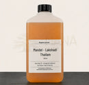 Eine klare plastikflasche mit schwarzem verschluss enthält 1000ml bernsteinfarbenes lakshadi thailam für tägliche abhyanga