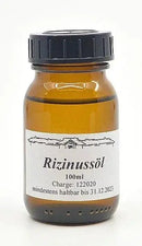 Ein 100ml midgard kalari ayurvedisches rizinusöl in einer kleinen bernsteinfarbenen glasflasche mit schwarzem deckel aus dem mana shop