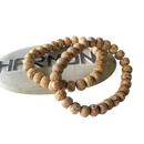 Natürliches lotus-samen-armband mit natürlichen beigen holzperlen und dunklen braunen sprenkeln von mana shop