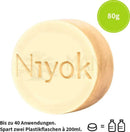 Pale gelber runder niyok feste dusche solid shower seife mit grünem touch und 80g gewicht
