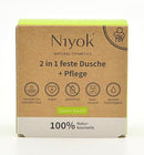Niyok Feste Dusche & Pflege 80g, festes Körperpflegeprodukt, zeigt die feste Seife in einer weißen Verpackung.
