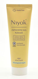 Tube Niyok Zahncreme aus Kokosöl mit Zitronengras & Ingwer (schützt Zähne und Zahnfleisch), vegan, ohne Fluorid, in beiger Kreide-Tube.