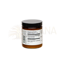 Ein glas mit schwarzem deckel und weißem etikett enthält ein bernsteinfarbenes paavani ayurveda kraut für hormonelles gleichgewicht und stress