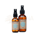 Zwei bernsteinfarbene glas-sprühflaschen mit schwarzen kapseln und paavani ayurveda pitta aromatherapie spritzer label
