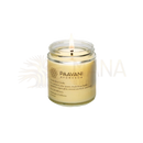 A lit creamy-yellow paavani ayurveda trataka ghee candle in a clear glass jar for ayurvedic meditation