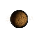 A dunkelbraune, fein gemahlene tridoshic spice blend in einer schwarzen keramikschale von paavani ayurveda fördert nährstoffaufnahme