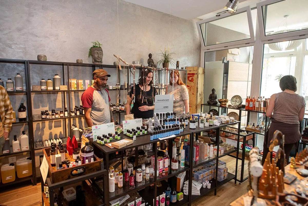 Bio-Kosmetik und Aromatherapie Produkte im Schweizer Lifestyle-Shop mit Kunden und Yoga-Decor