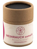 Ein brauner zylinderförmiger karton mit schwarzem boswellia carteri harz und weißem label für hippie rose gift set