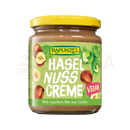 Ein glas rapunzel creme haselnuss vegane haselnusscreme mit gelbem deckel und grünem etikett im mana shop