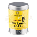 Vibrante gelbe zylindrische dose mit silbernem deckel von sonnentor mit ingwer kurkuma latte etikett für mana shop