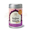 Ein rosa und lila beschrifteter metallbehälter classic ayurveda süsses glück gewürz 70g süssstoff
