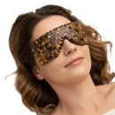 Eine tiger eye gesichtsmaske aus gewebtem tigerauge in warmen goldbraunen tönen mit perlenrand von artisans de madagascar bei mana shop