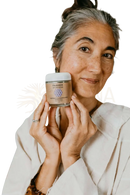 A beige glass jar with white lid labeled palavani ayurveda containing tridosha cleanser with bentonite clay for radiant skin