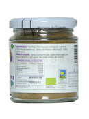 Ein klarer glasbehälter mit weißem deckel enthält triphala churna bio pulver aus terminalia chebula und emblica officinalis