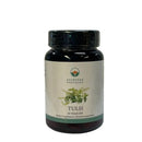 Dark amber glasflasche tulasi kapseln mit grünem botanischem etikett tulsi von ayurveda specialist mana shop heiligem basilikum