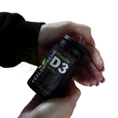 Schwarze zylindrische kapsel-flasche feels supreme vitamin d3 5000i mit grünem blatt-logo zur unterstützung des immunsystems