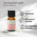 Eine kleine bernsteinfarbene glasflasche mit schwarzem deckel und rosa etikett zen arome ätherische öl-synergie sensualität für diffusor