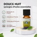 Kleine bernsteinfarbene glasflasche mit schwarz geriffeltem verschluss und grüner etikette zen arôme douce nuit synergie ätherische öl-synergie nacht duftkomposition aus natürlichen ätherischen ölen