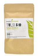 Ein brauner papierbeutel mit 50 tulsi kapseln bio von zimmerli adaptogene für stressresistenz und balance